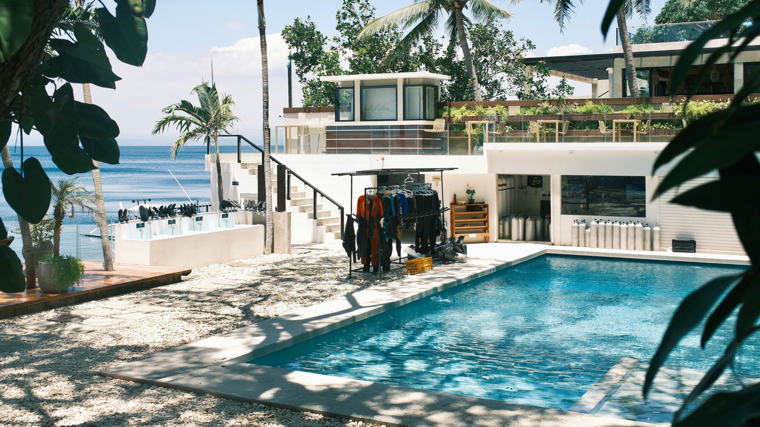 Sunset ambiance at Solitude Acacia Resort, highlighting the serene poolside and bar beside the tranquil ocean