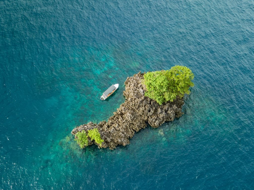 An aerial photo of a tiny island in Raja Ampat