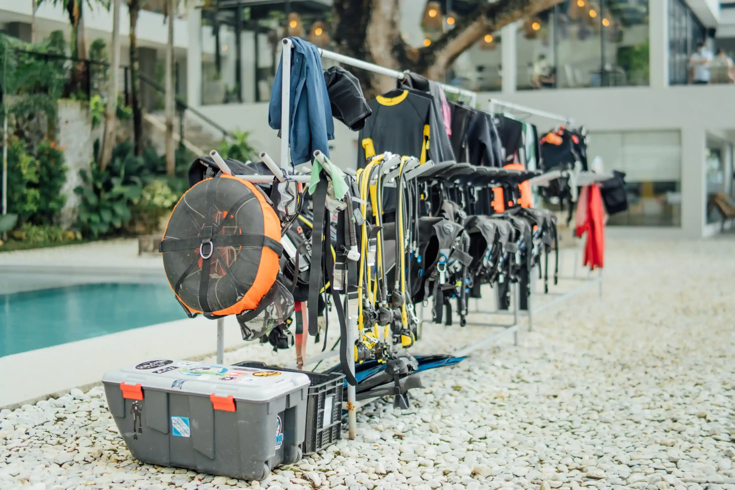 Scuba diving gear rack with wetsuits and BCDs
